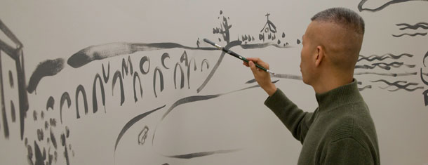 Cai Guo-Qiang painting a mural in the Sackler Center for Arts Education